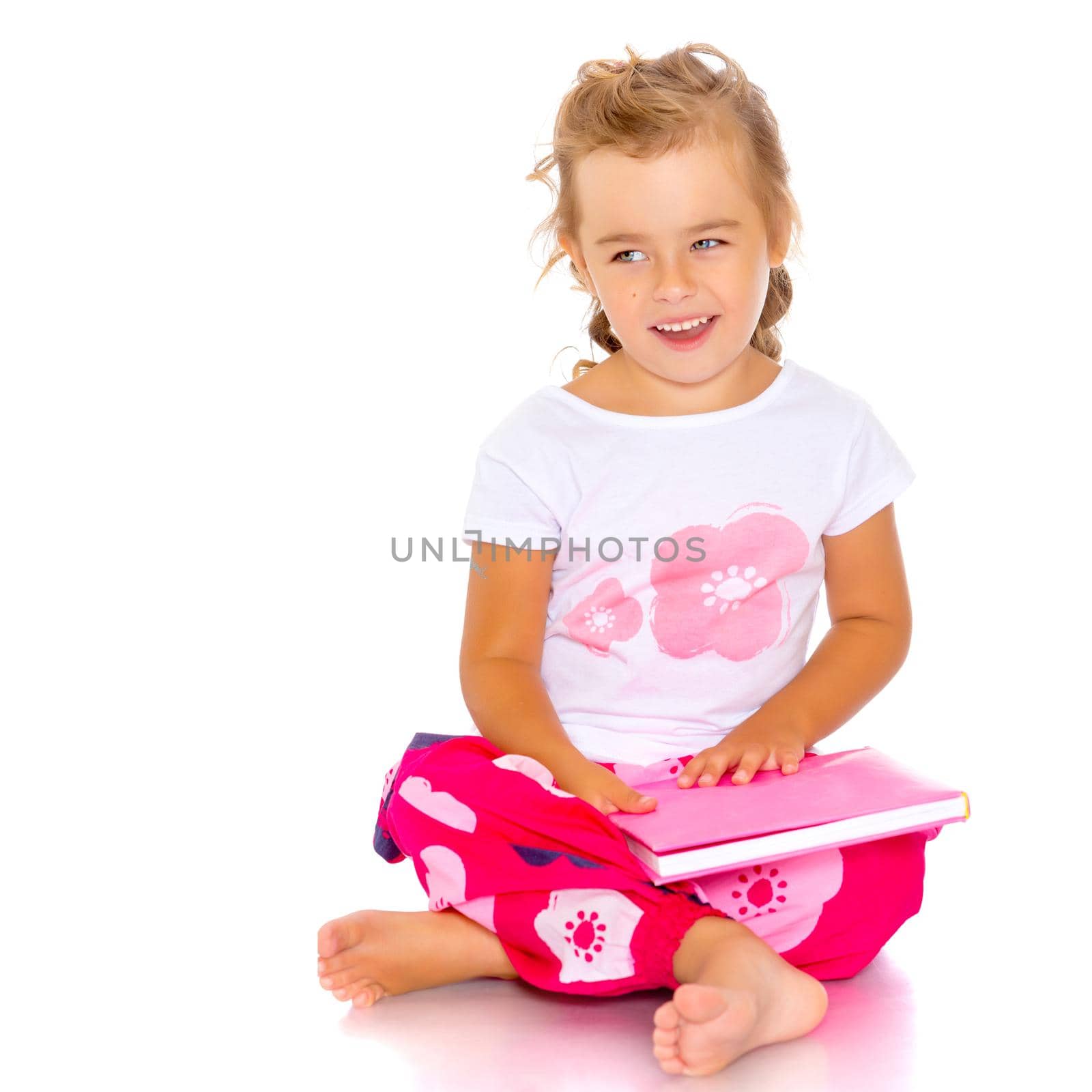 Little girl with book. The concept of education in school or kindergarten. Isolated over white background