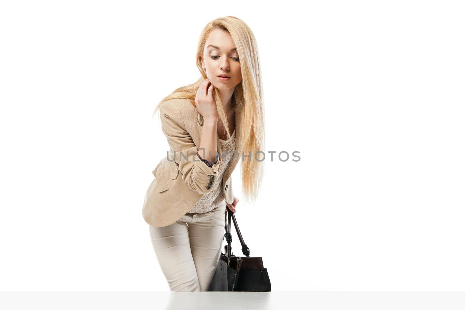 Young excited woman looking at the shop window isolated over white