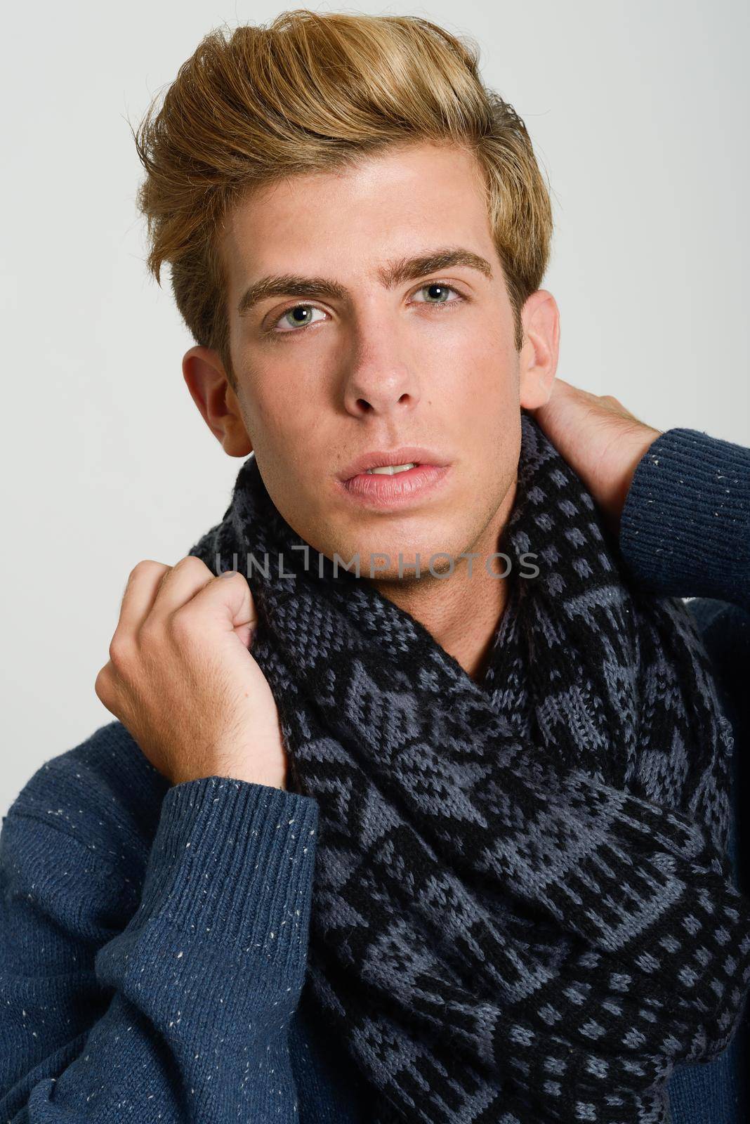 Close-up portrait of handsome blonde man wearing scarf