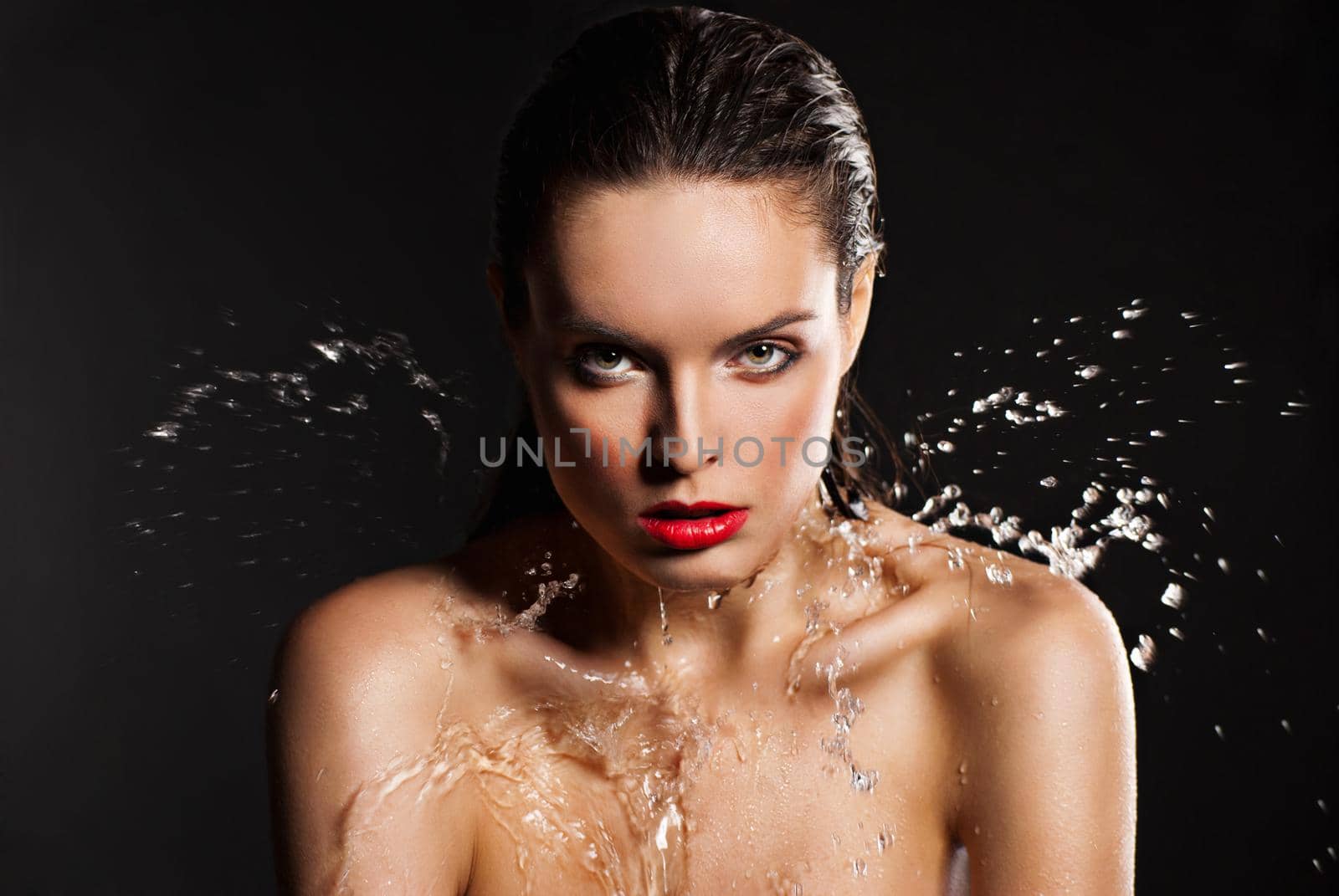 Portrait of young sensuality beautiful woman under the stream of water - blue background