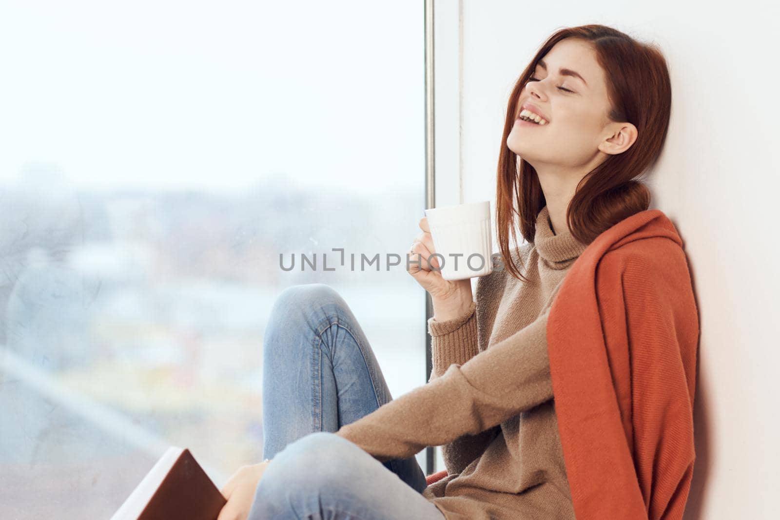 woman looking out the window on the windowsill Comfort weekend rest. High quality photo