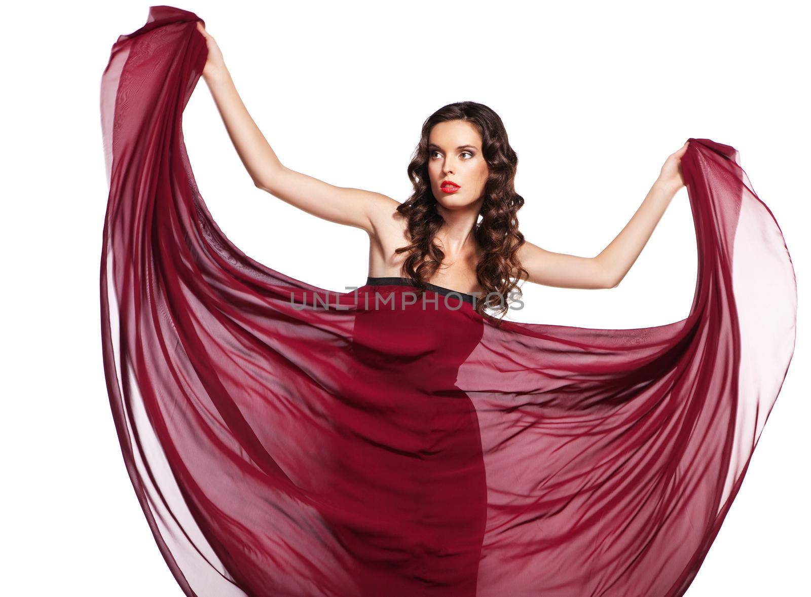 woman in red dress waving flying on wind flow with long curly hair isolated