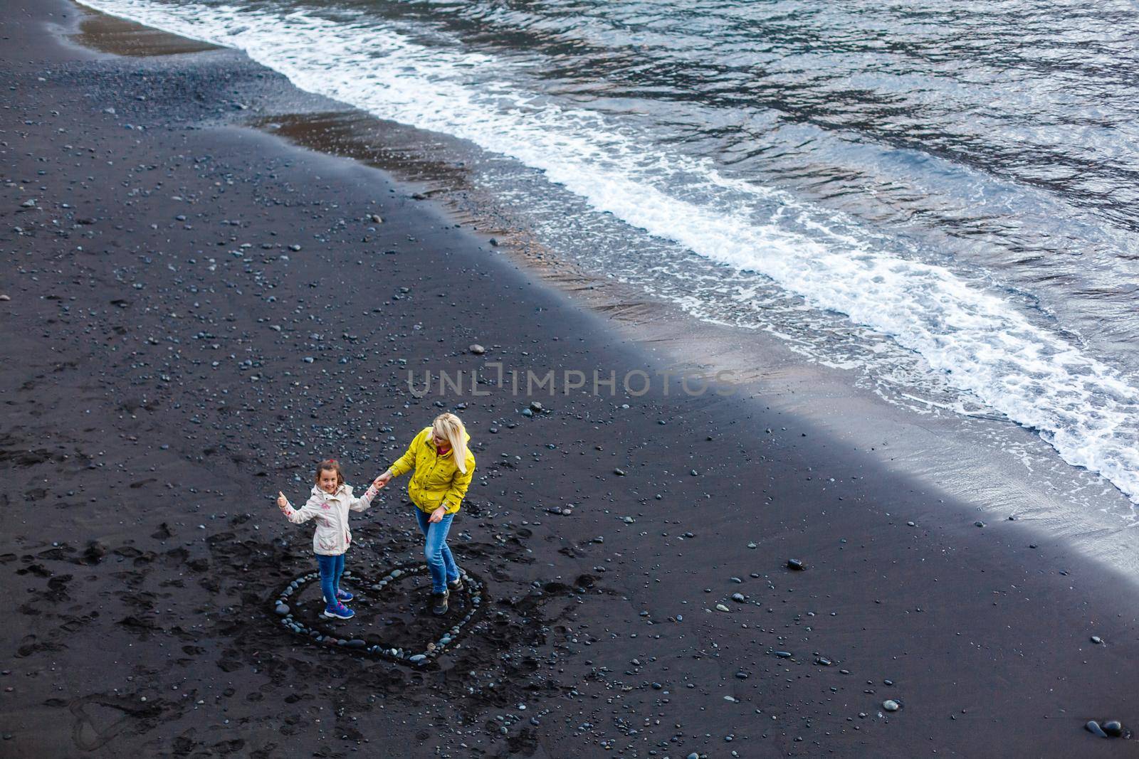 Family holiday on Tenerife, Spain, Europe. Mother and daughter outdoors on ocean. Portrait travel tourists - mom with child. Positive human emotions, active lifestyles. Happy young family on sea beach by Andelov13