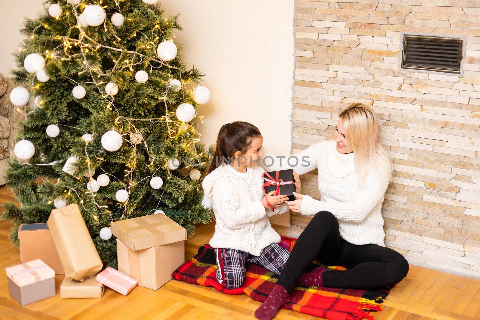 Mother giving her daughter christmas gift.