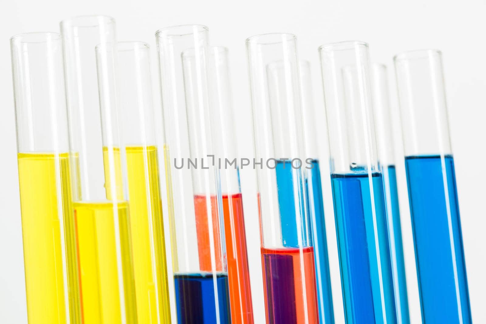 Science laboratory research and development. Modern biochemistry industry mockup. Close up test tubes with color liquid on white background. Chemical manufacture concept with glass equipment.