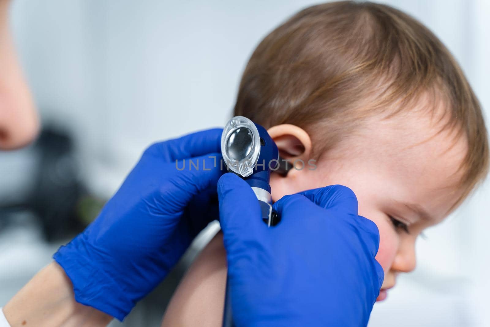 Pediatrician doctor concept. Children medical care. One year old baby girl examined by female pediatrician in clinic office. Child visiting doctor for health check-up. Doctor examine little patient.