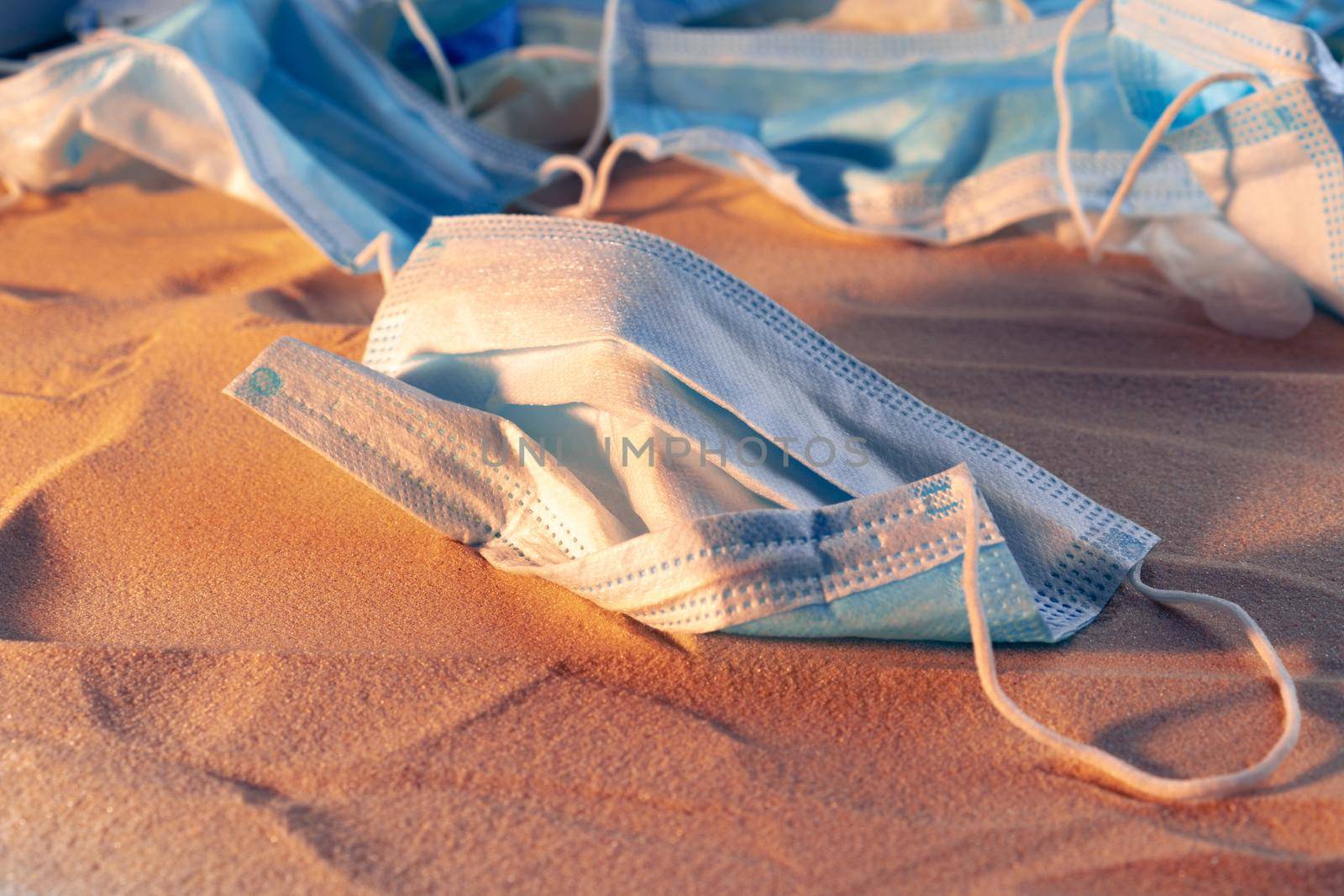 Protective facial mask on the natural outdoors beach background by Fabrikasimf