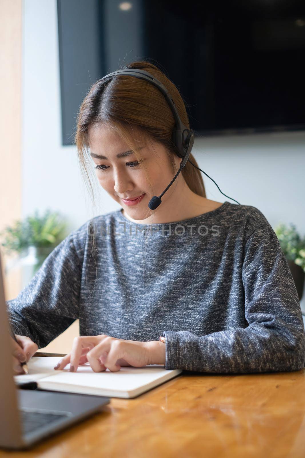 Customer service representative with a headset and work at home. business support team concept. by itchaznong