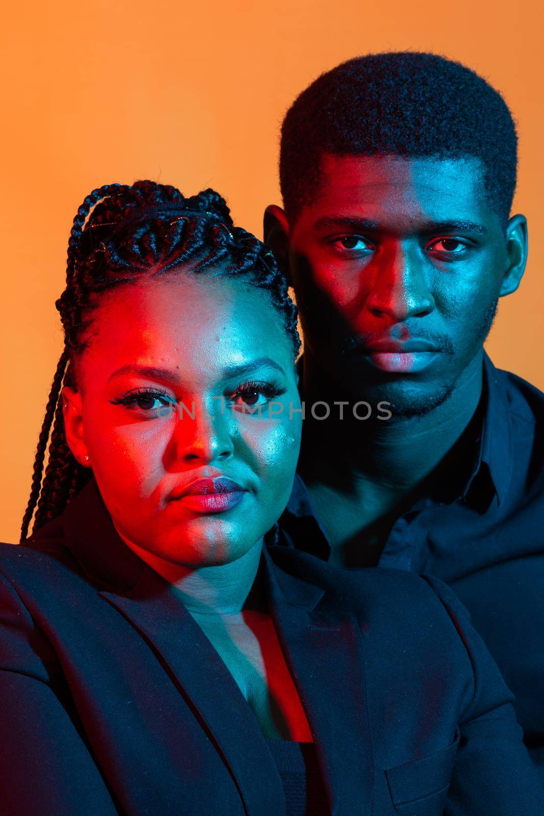 Dark neon portrait of young african american man and woman. Red and blue light. by Satura86