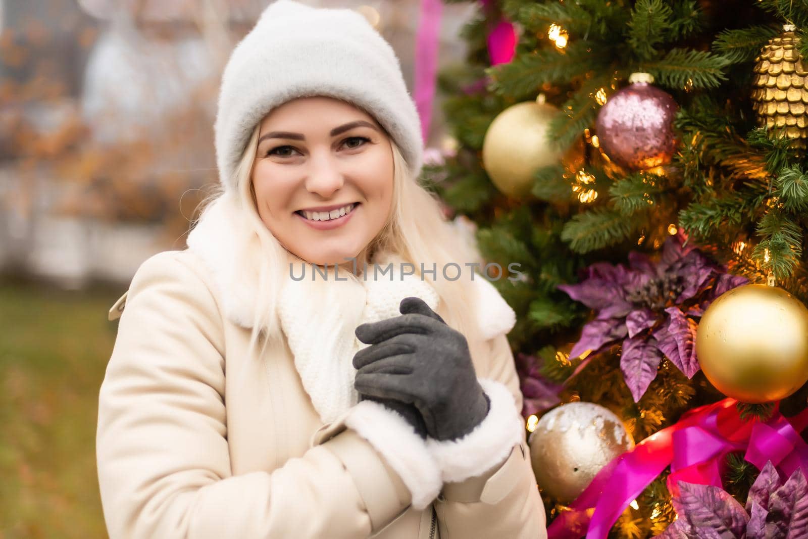 woman and photo zone christmas tree and rocking chair on the street