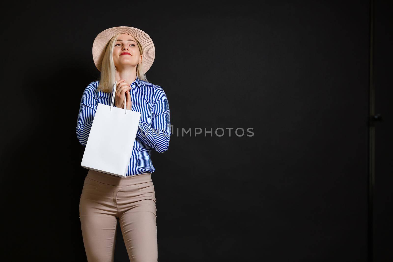 Shopping woman holding bags, isolated on black background. black friday concept