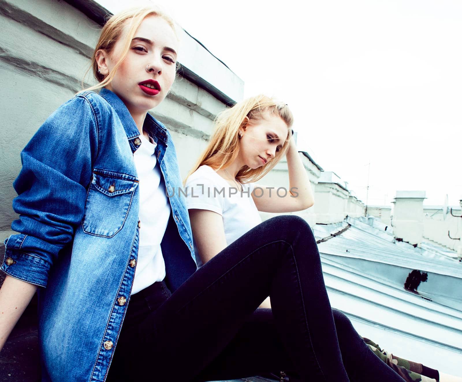 two cool blond real girls friends making selfie on roof top, lifestyle people concept, modern teens closeup