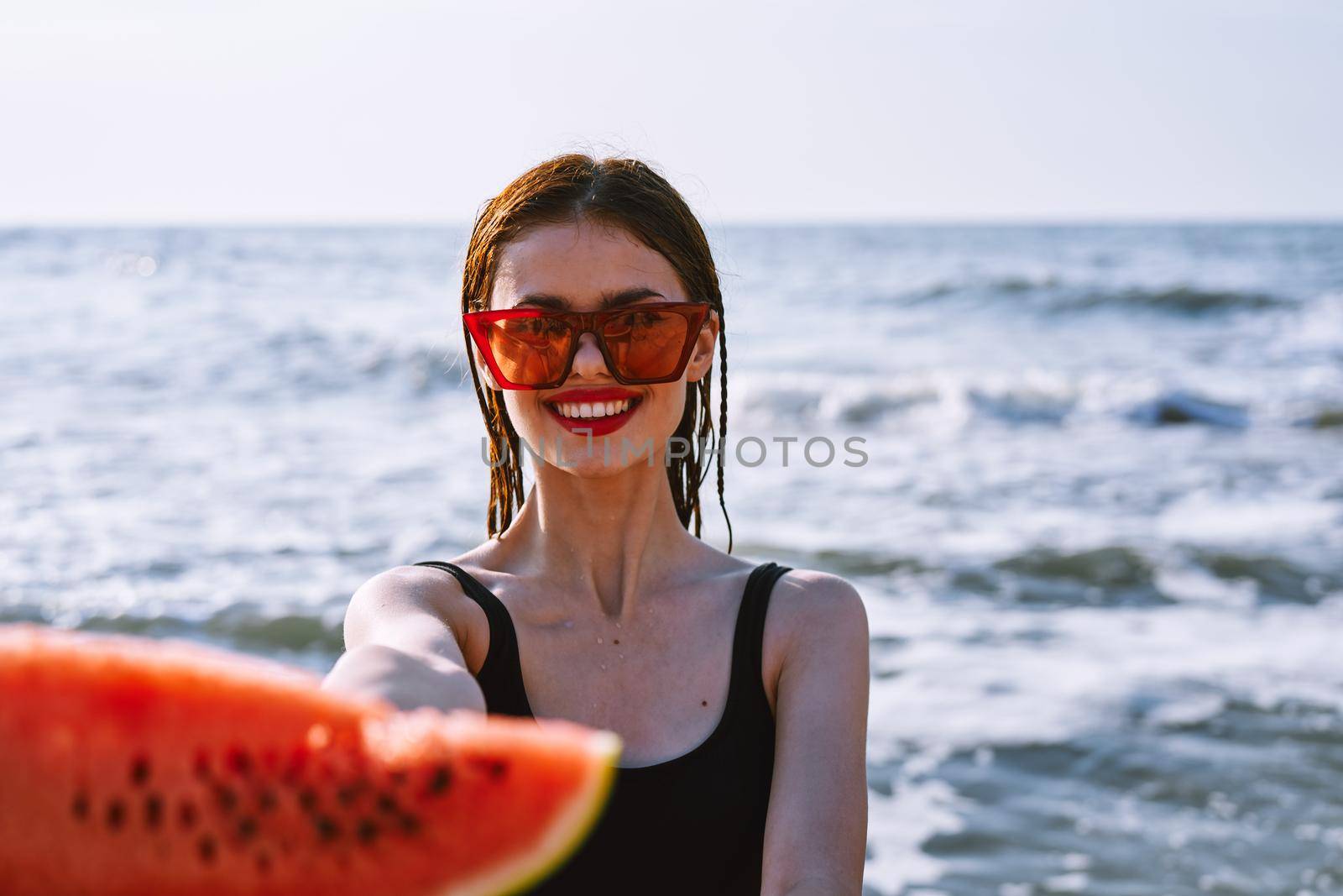 cheerful pretty woman in black swimsuit watermelon fashion travel. High quality photo