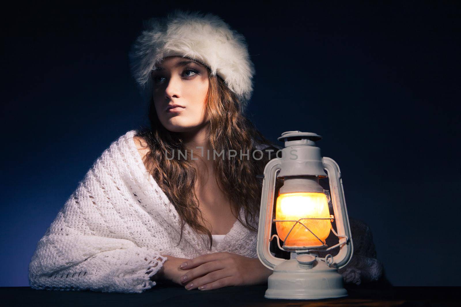 beautiful woman sitting with lantern over dark by Julenochek