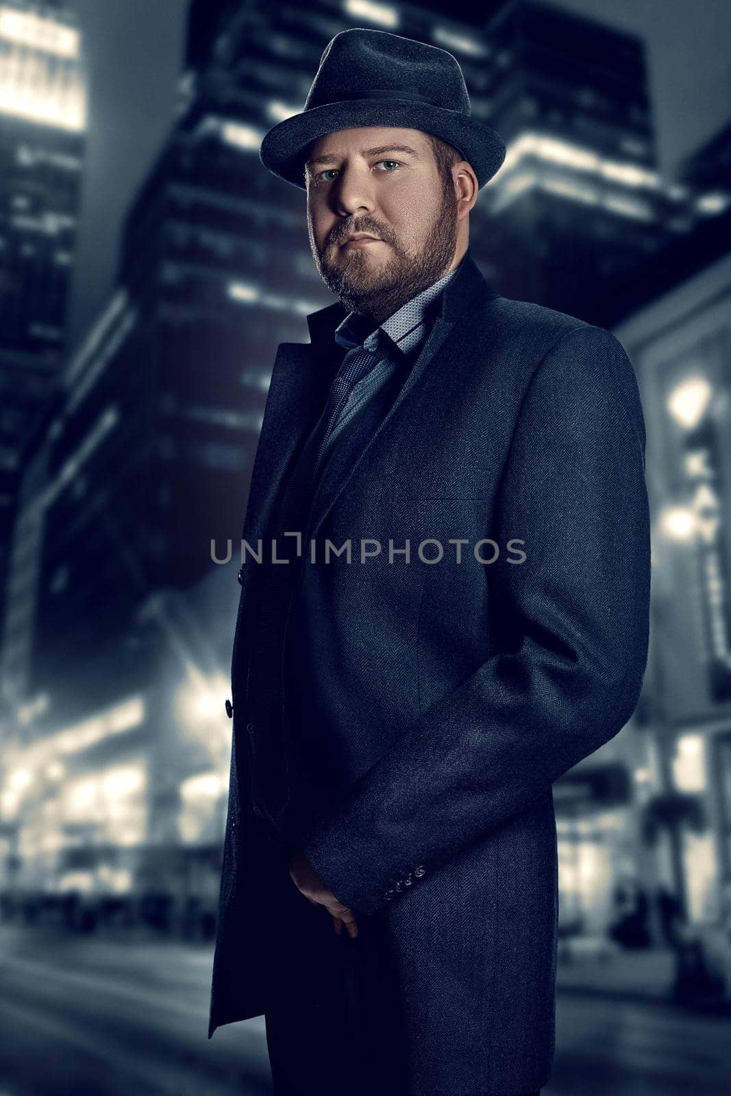 Film noir. Retro style fashion portrait of a detective. A man in a suit against a background of a night city by nazarovsergey