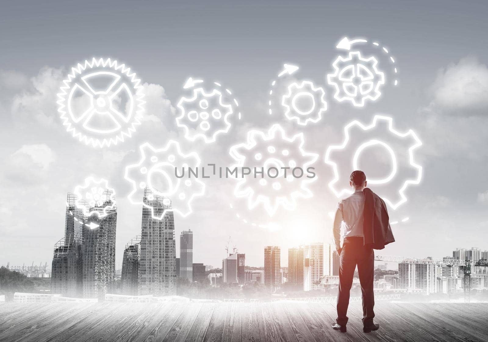 Back view of businessman looking at modern city and drawn gear mechanism