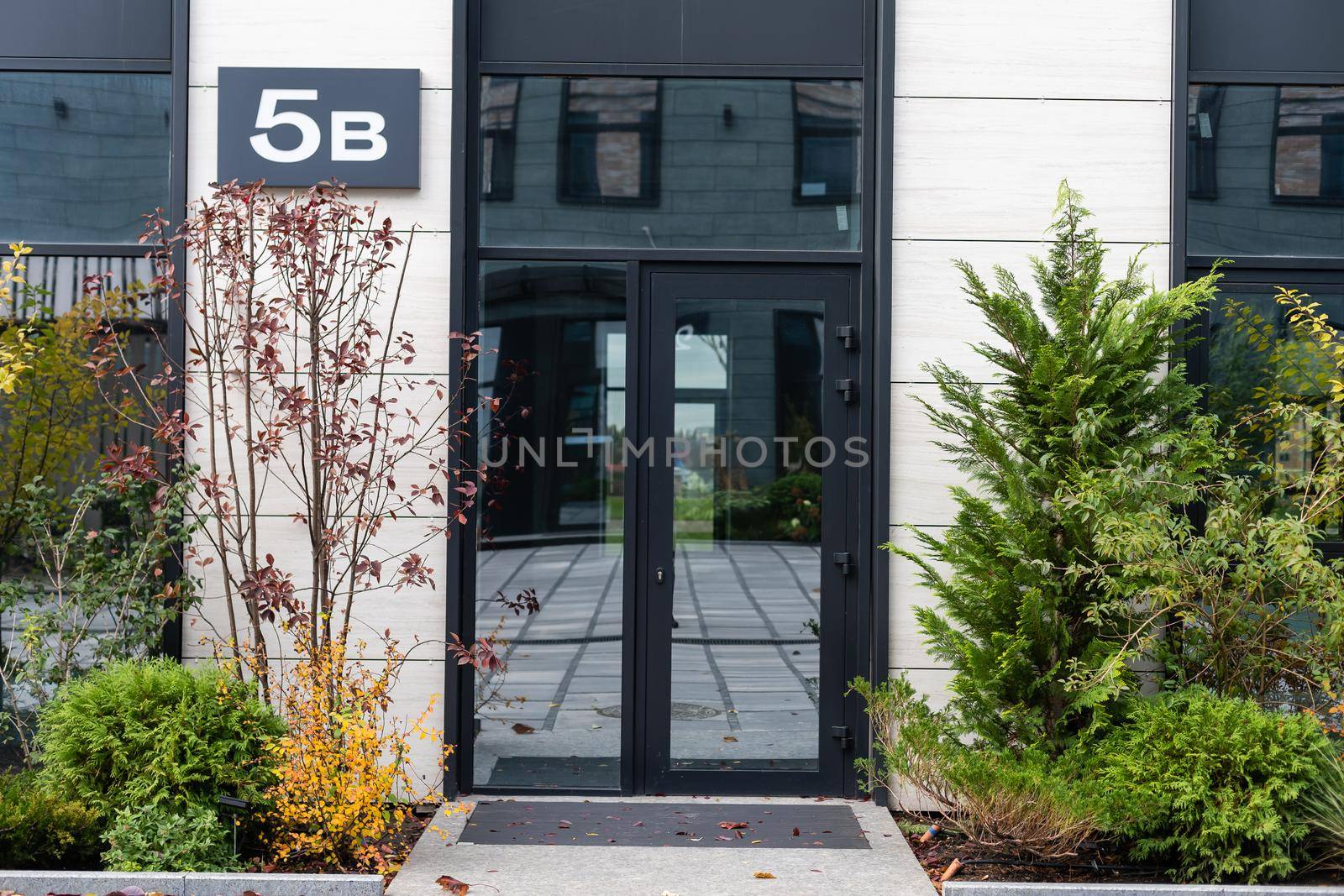 Outside solid glass door with building exterior.