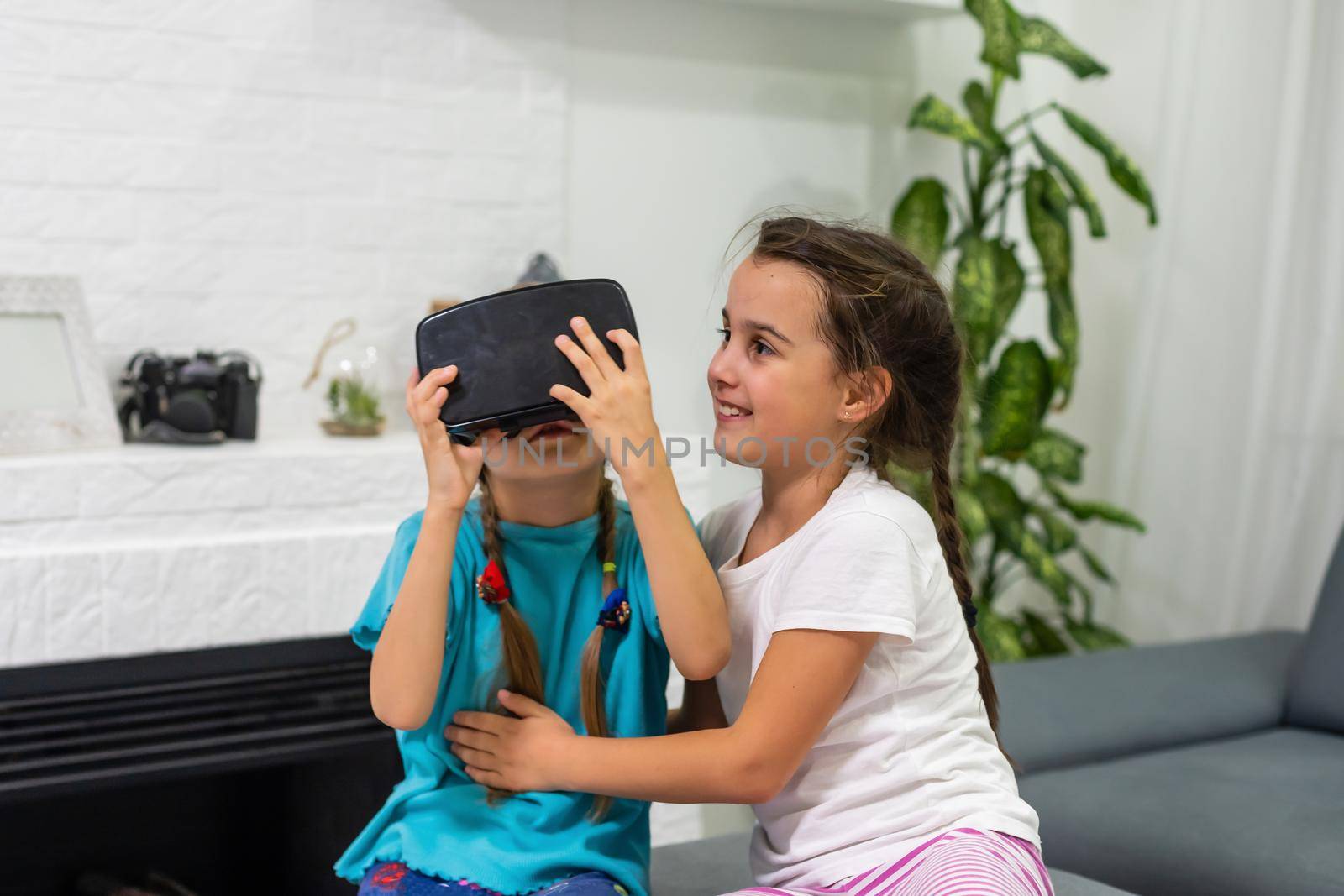 two little girls playing video games virtual reality glasses