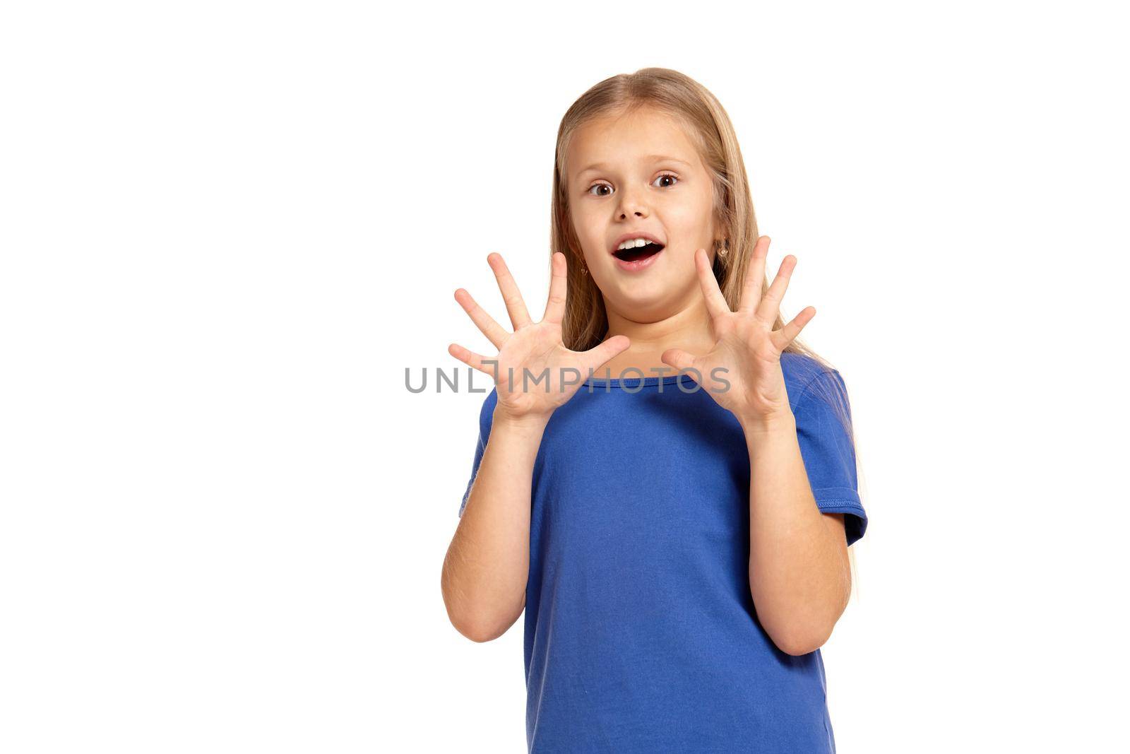 Portrait of adorable little girl isolated on a white background. in blue t-short with long white hair, surprised