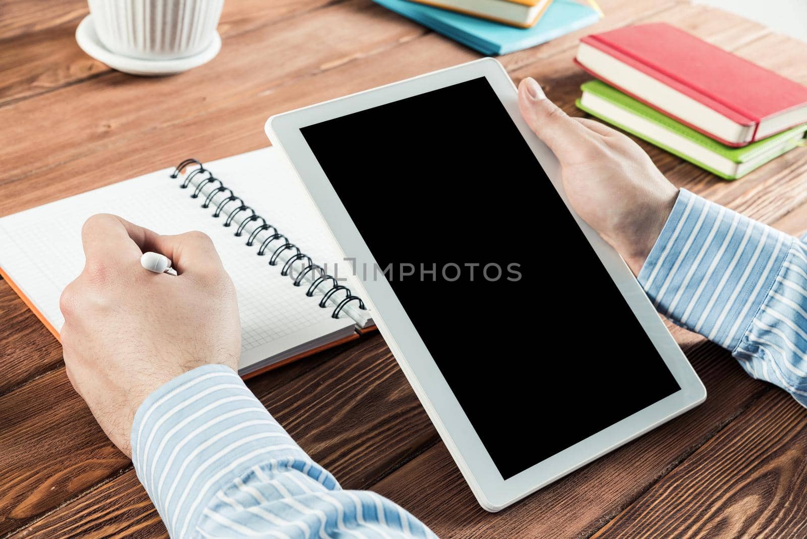 close-up of men's hands with a computer tablet. Businessman works in the office