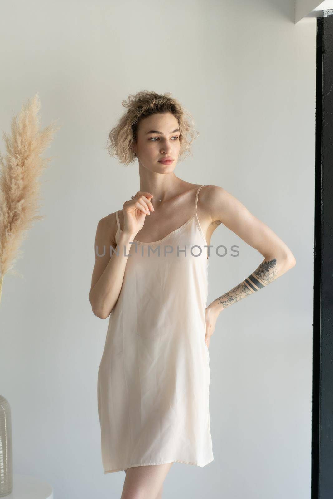 young beautiful woman posing in white lingerie in studio by Igorsmirnof