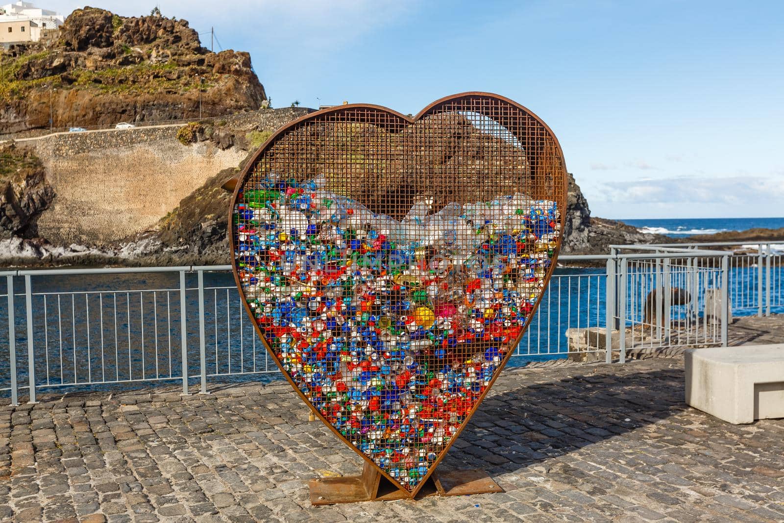 Conceptual garbage can heart-shaped for plastic nuts. Education in environmental protection.