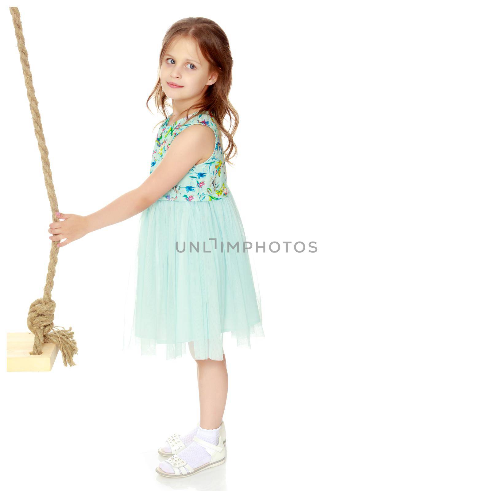 Fashionable little girl in a dress. Beauty and style in children's clothes. Isolated over white background