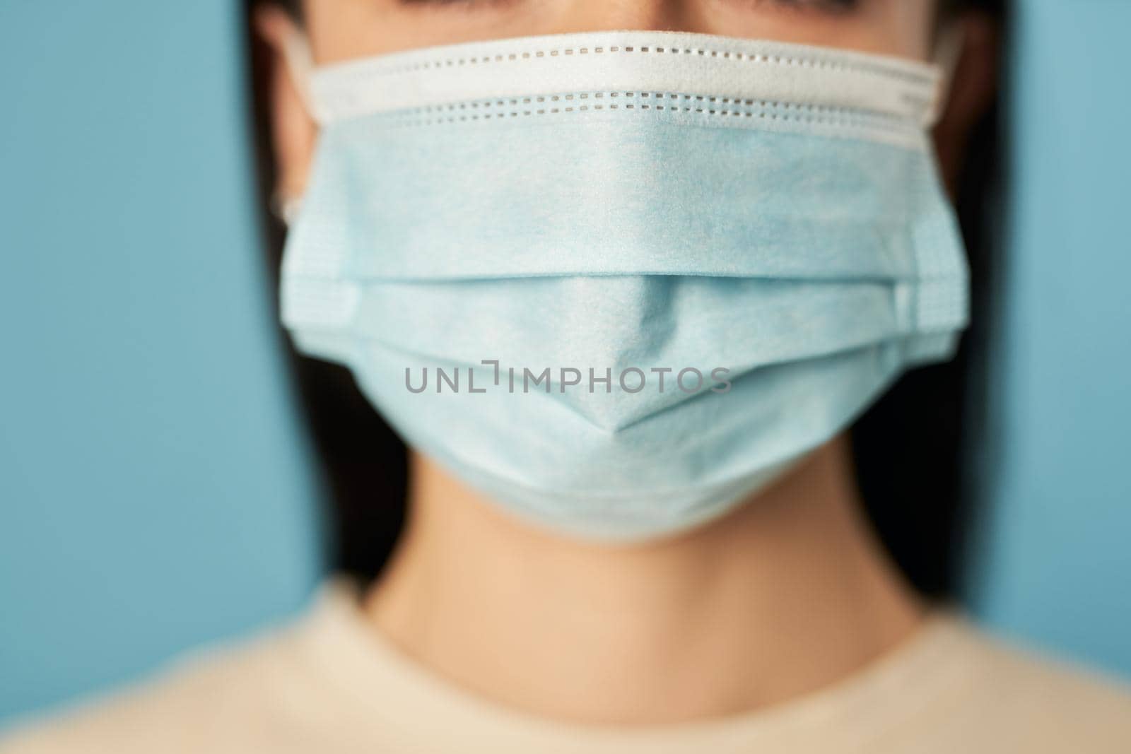 Close up of woman wearing protective face mask. Quarantine, coronavirus concept. Copy space