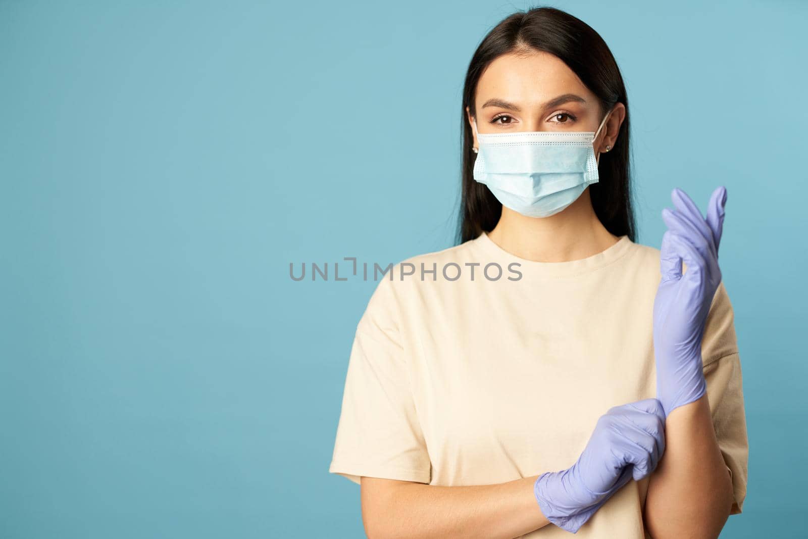 Beautiful brunette wearing protective gloves during quarantine by friendsstock