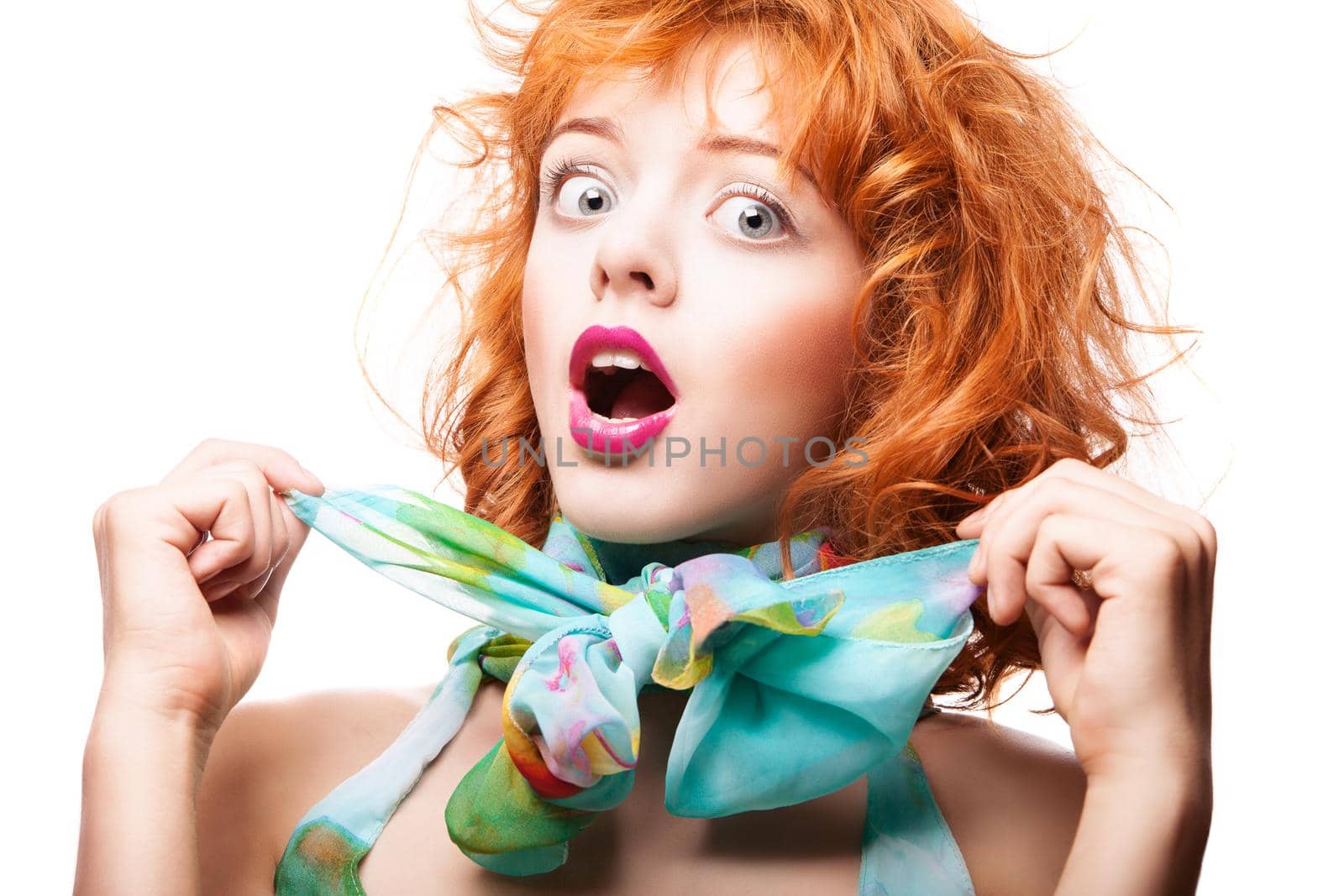 Girl with beautiful red hair and colorful dress and fabric over white background