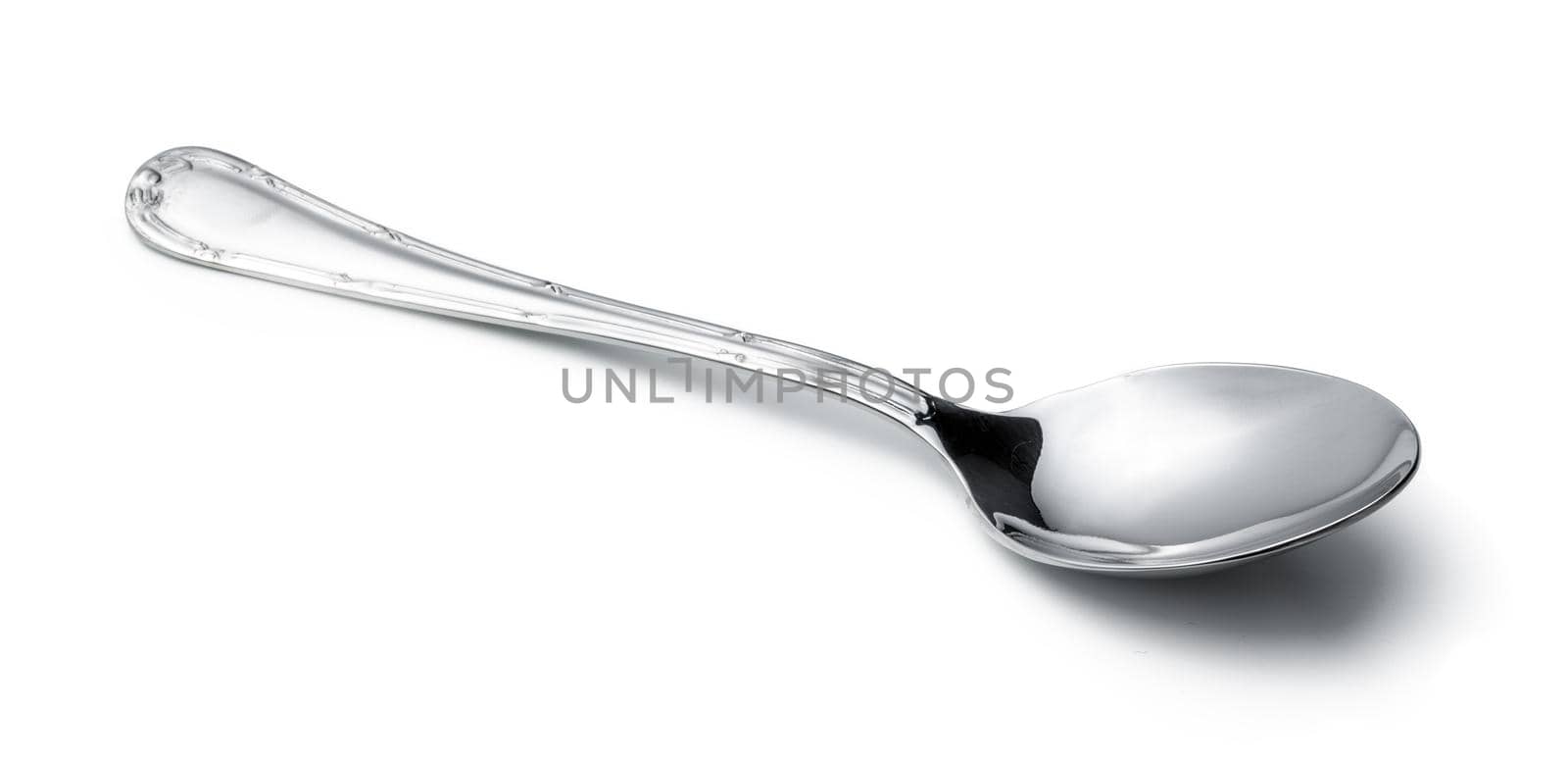 Silver shiny spoon isolated on white background. Close up.