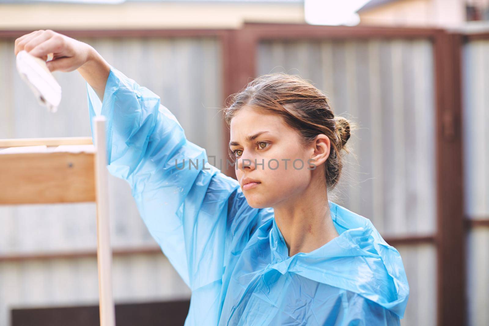 woman house painter renovating wood fittings at home. High quality photo