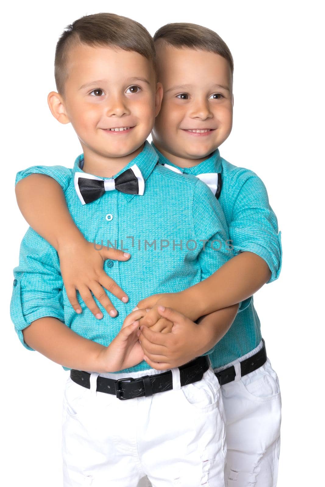 Two cute little boys, brothers close-up. The concept of a happy childhood, the development of a child in the family. Isolated on white background.