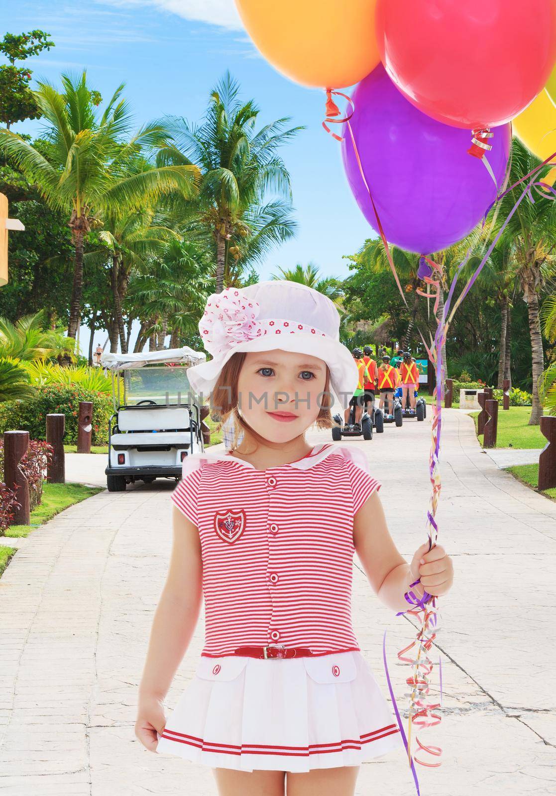 Girl holding balloons by kolesnikov_studio
