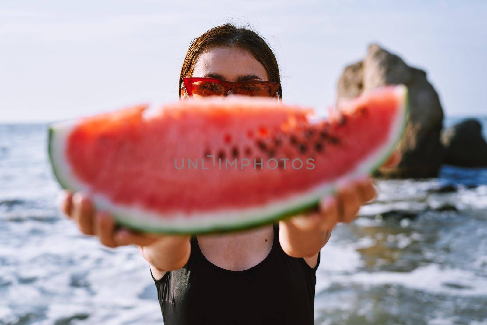 cheerful pretty woman in black swimsuit watermelon fashion travel. High quality photo