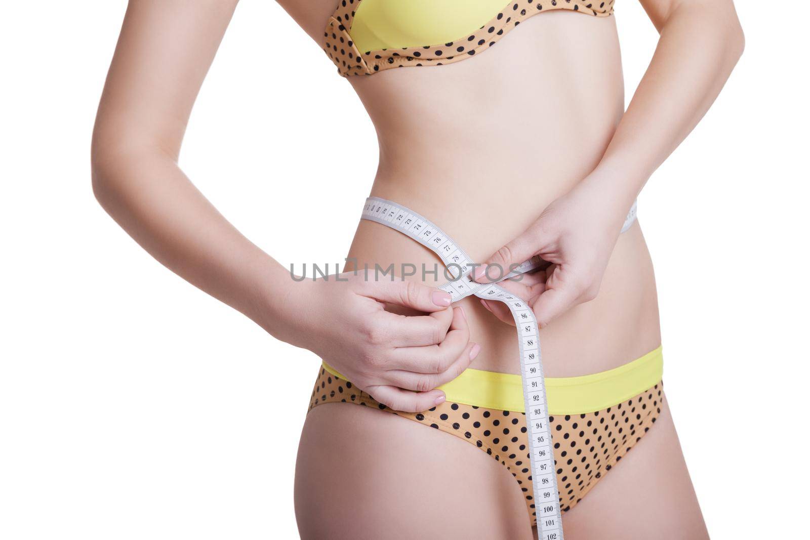 Woman measuring her slim body isolated on white background