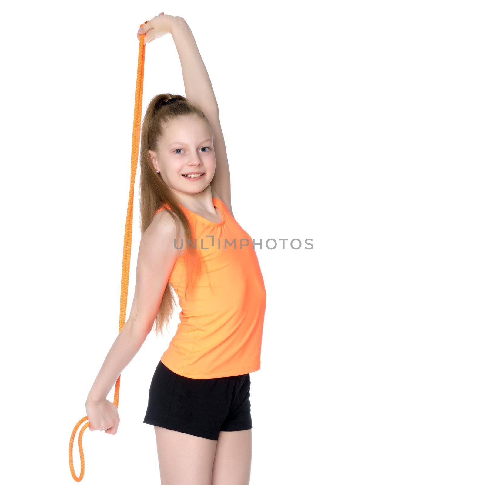 A girl gymnast performs exercises with a skipping rope. by kolesnikov_studio