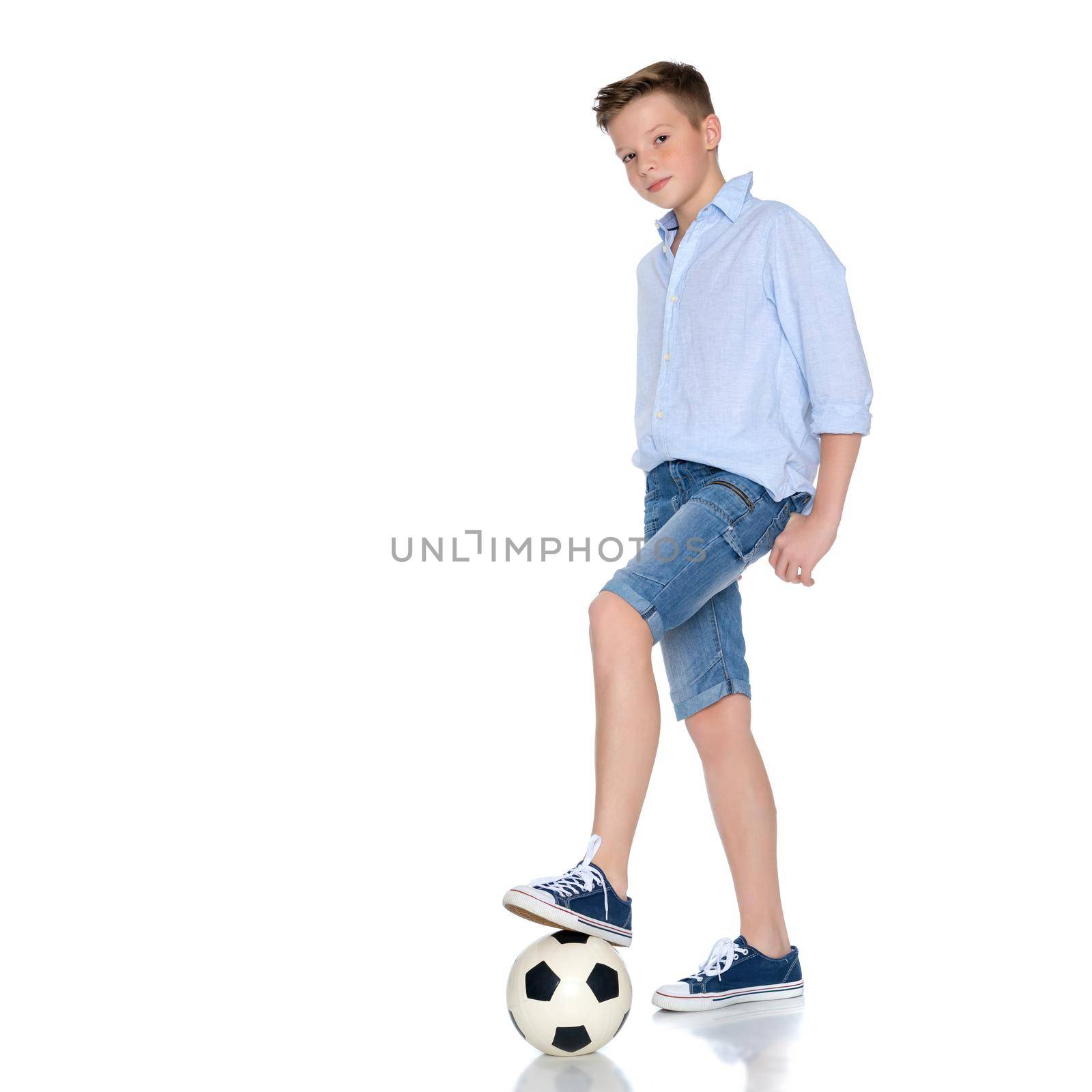 Sports boy teenager with a soccer ball. The concept of a healthy lifestyle, sport and fitness. Isolated on white background.
