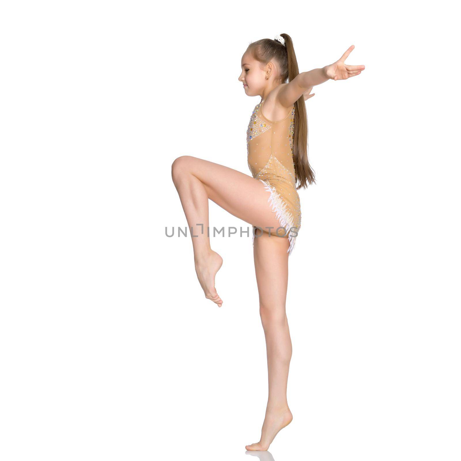 little girl gymnast performs an exercise. Balance on one leg with a grip. Sport concept, gymnastics, fitness. Isolated on white background.