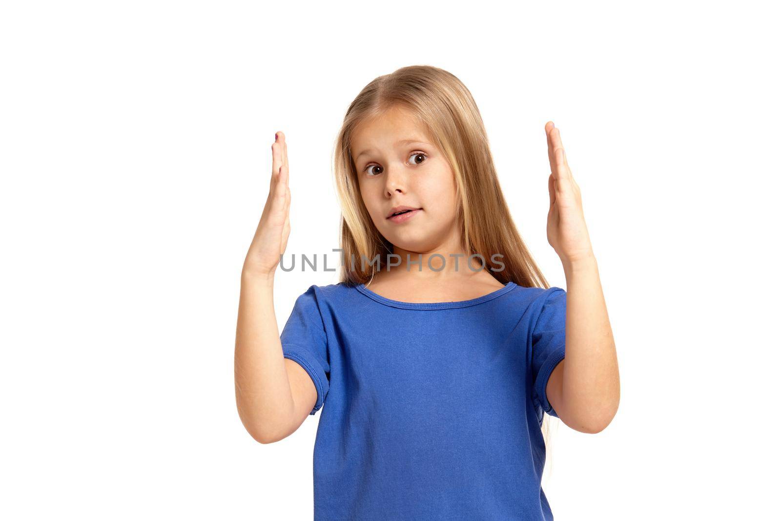 Portrait of adorable little girl isolated on a white background. in blue t-short with long white hair, showing something