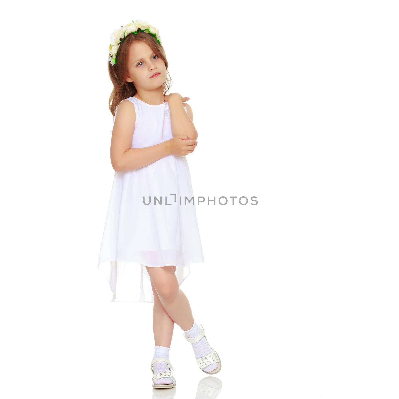 Fashionable little girl in a dress. Beauty and style in children's clothes. Isolated over white background