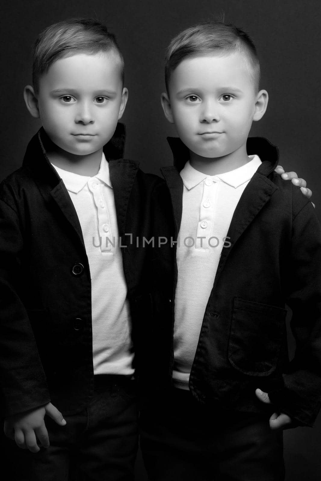 two little boys dressed in tuxedo. Isolated on white background