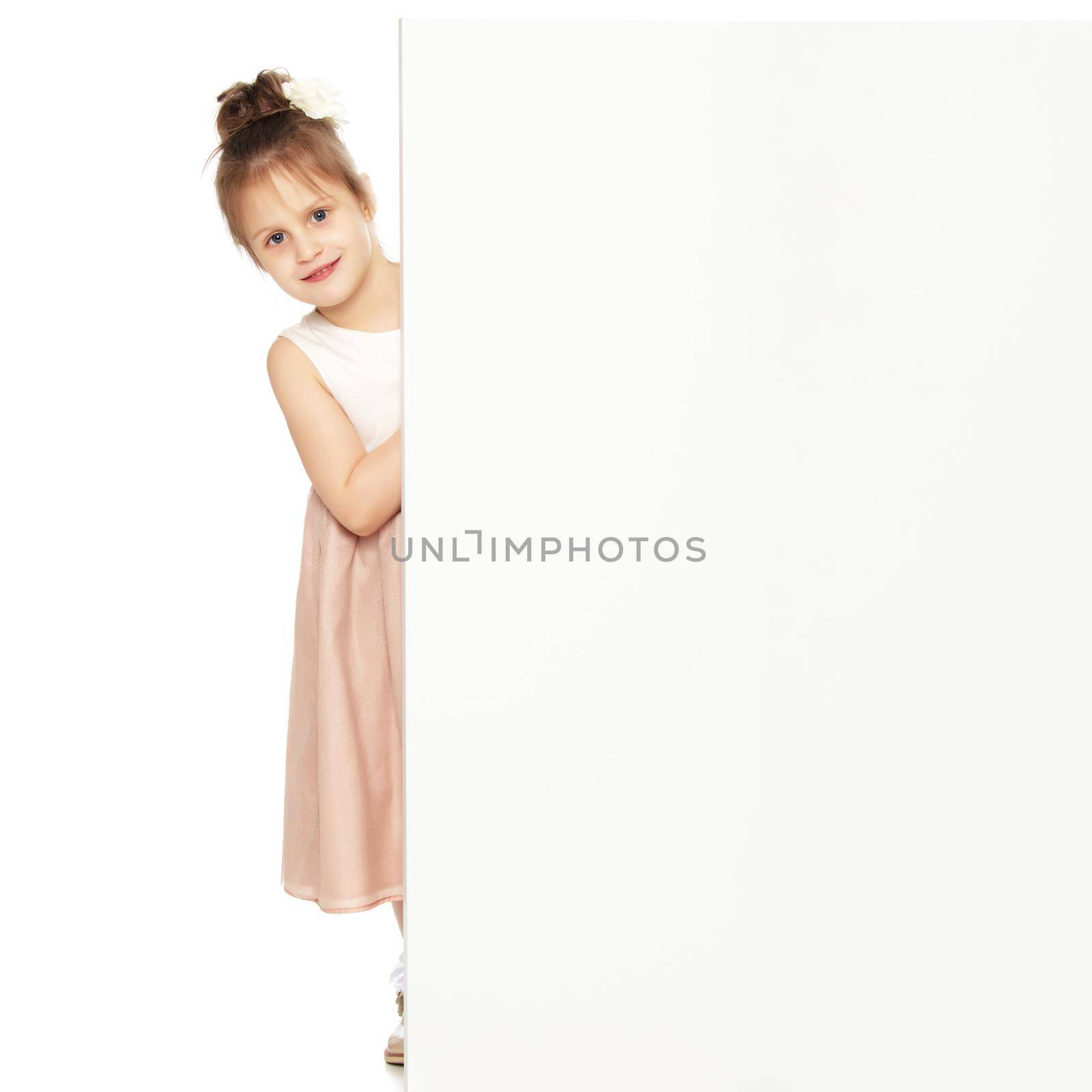 A little girl peeks out from behind the banner. by kolesnikov_studio