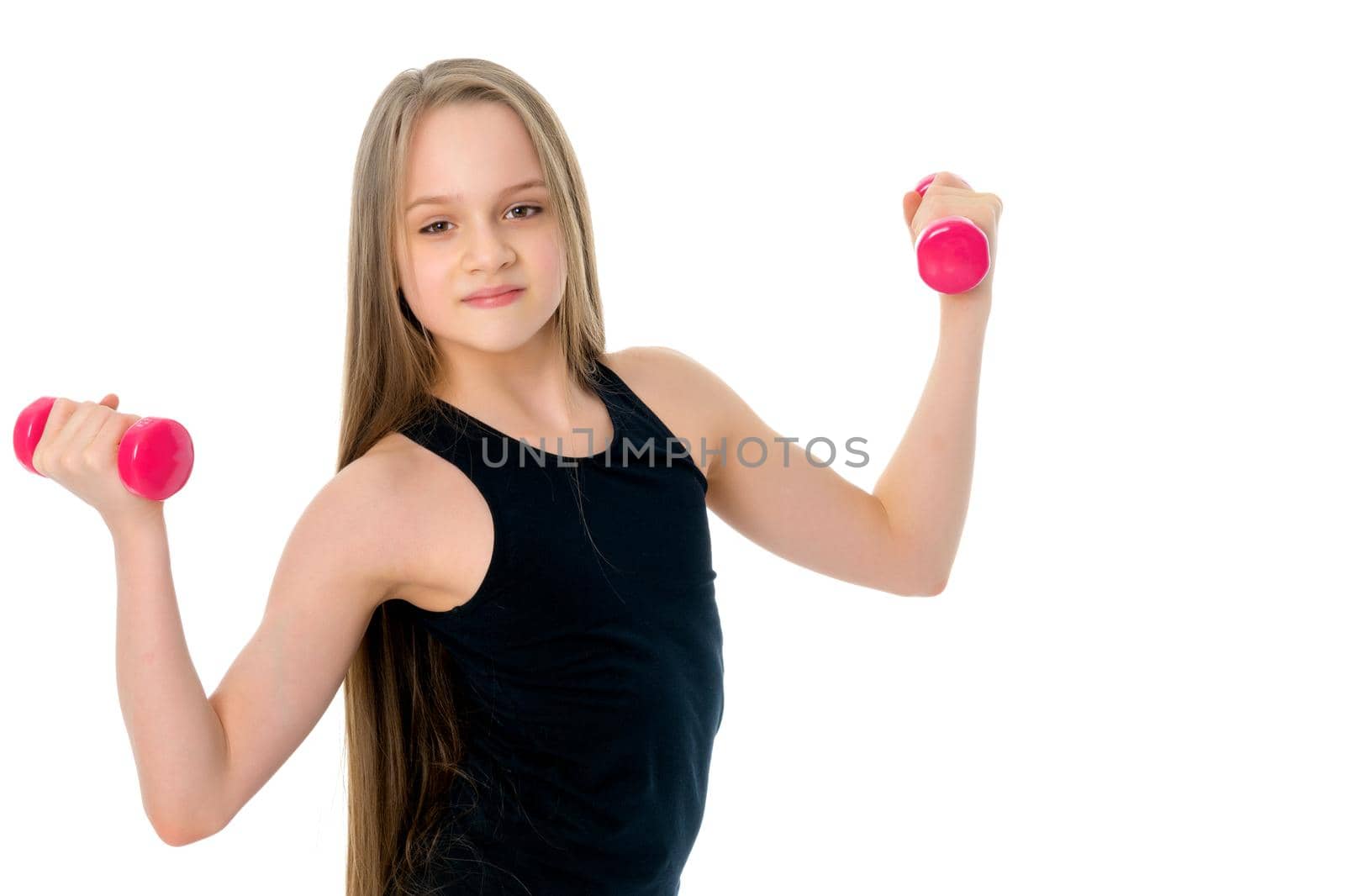 A cute little girl doing exercises with dumbbells. The concept of strength, health and sport. Isolated on white background.