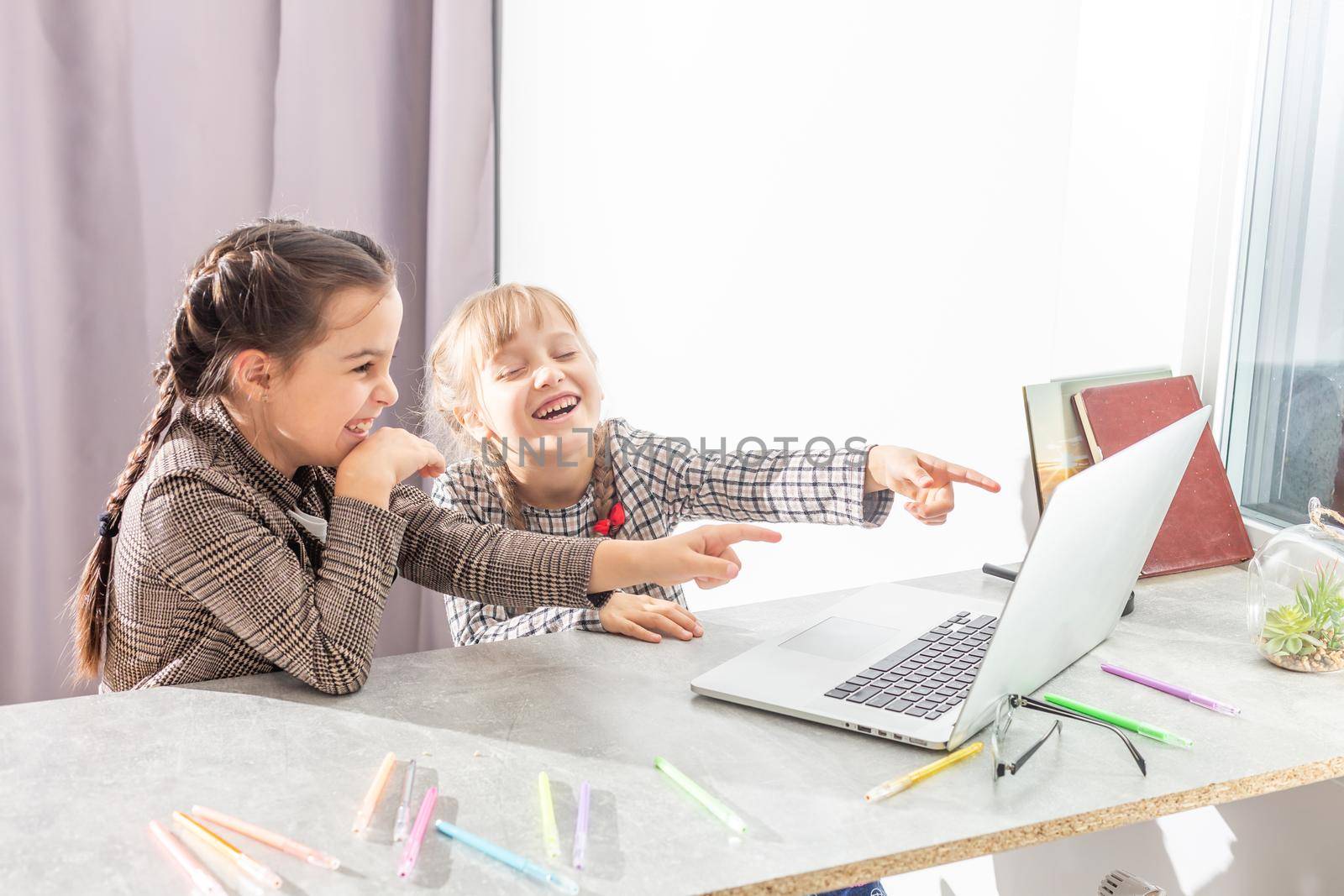 two little girls studying online. Distance Learning Online, e-learning, concept