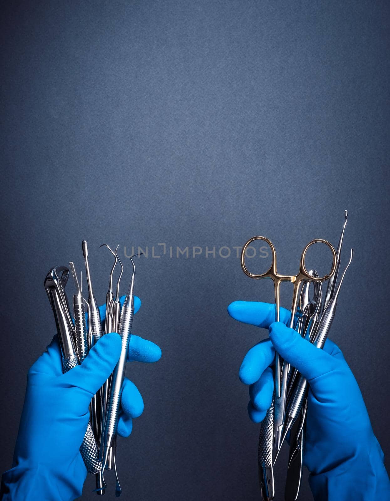 Hands in blue gloves holding metal dental equipment by GekaSkr