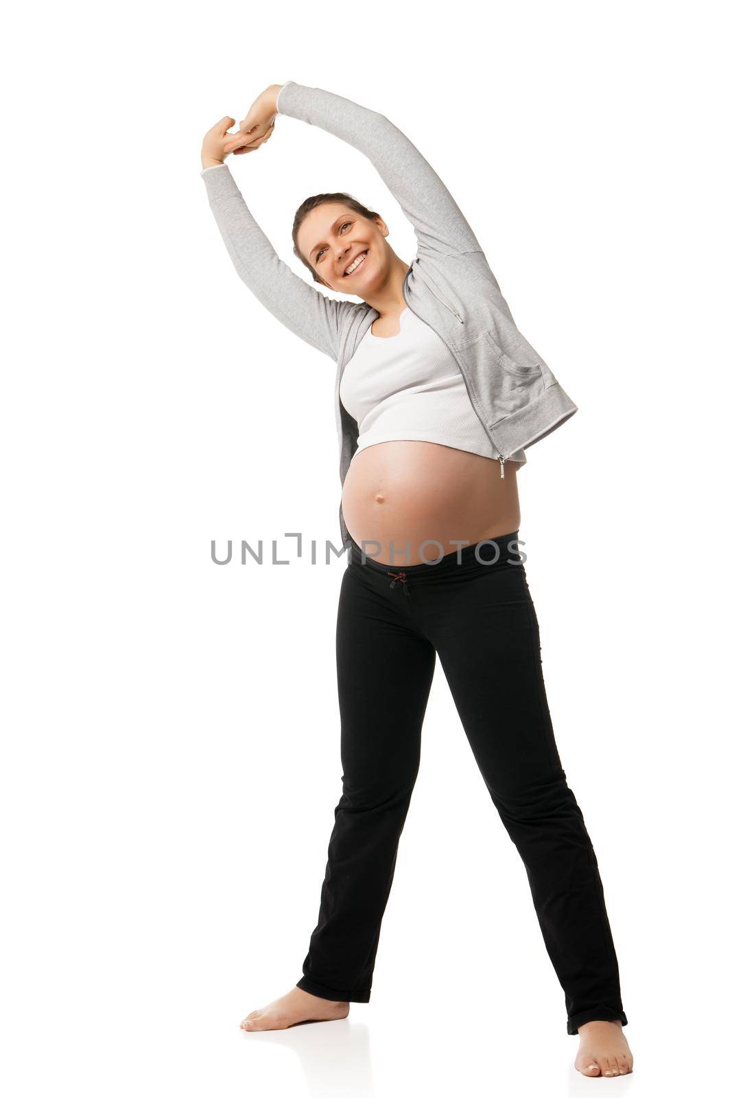 Beautiful pregnant woman smiling and doing exercises isolated