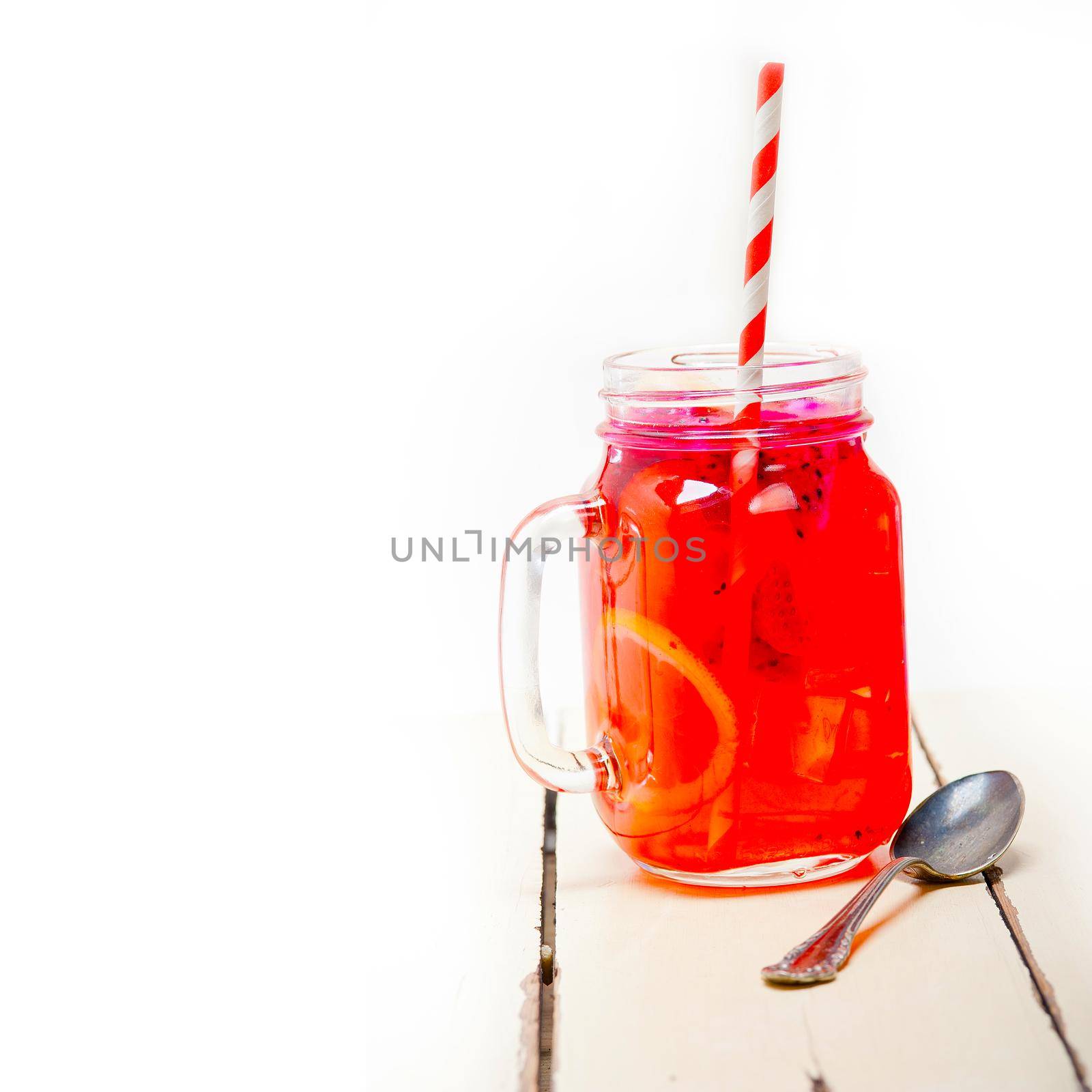 fresh fruit punch refreshing summer  drink over white rustic wood table