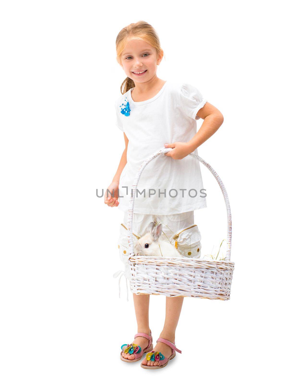 Little smiling blond girl holding white basket with white rabbit isolated on white background