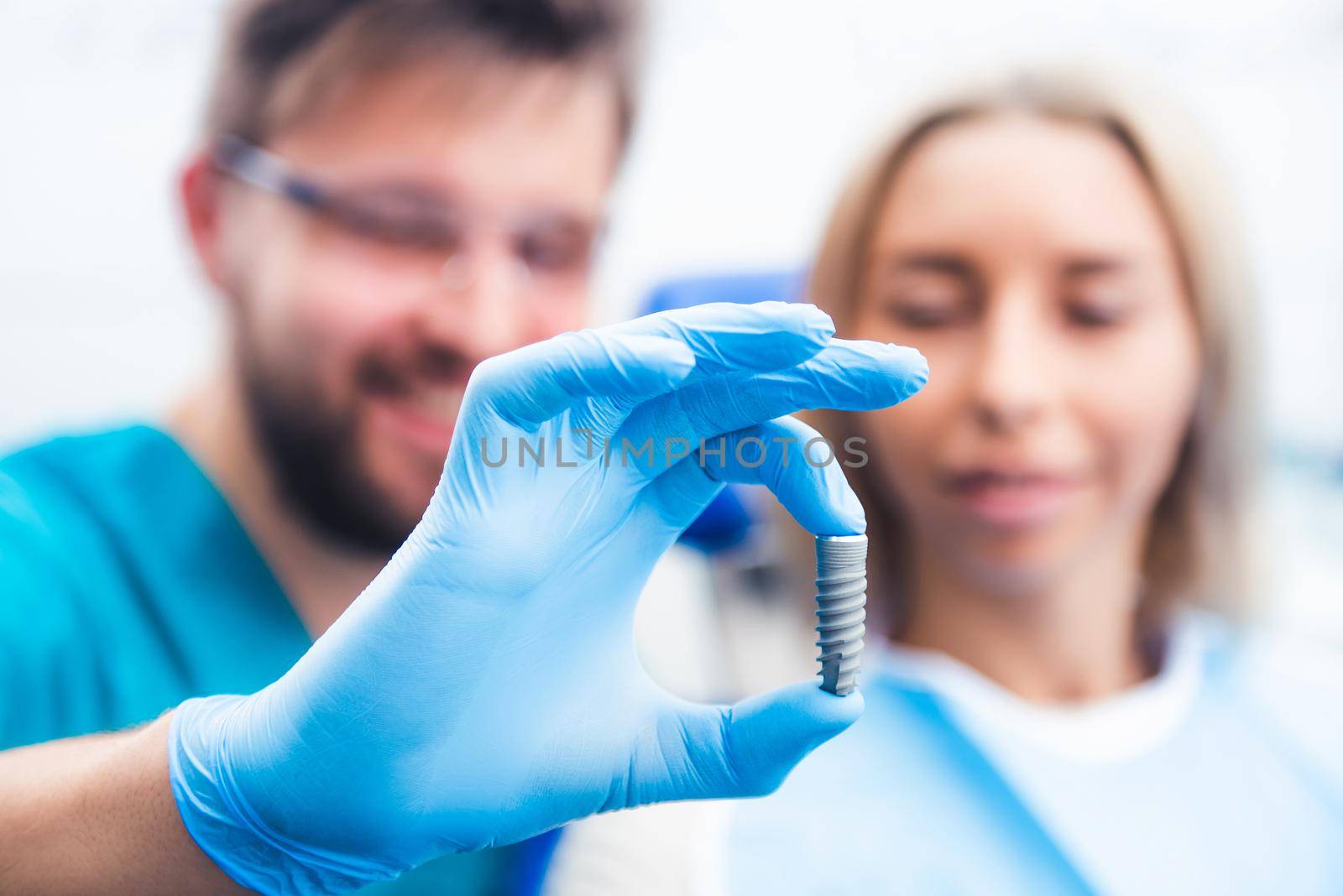 Dentist showing gray implant model by GekaSkr